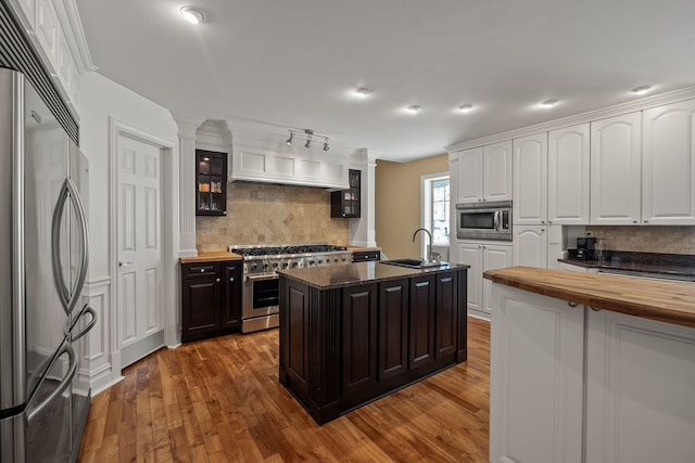 6705 College Park, Clarkston, MI 48346 - kitchen featuring built in appliances, decorative backsplash, a sink, and wooden counters