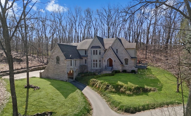 6705 College Park, Clarkston, MI 48346 - french country home featuring a front yard and stone siding