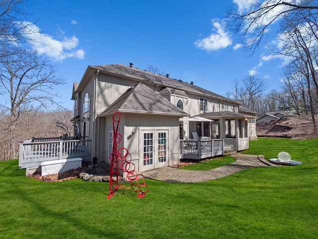 6705 College Park, Clarkston, MI 48346 - back of property with a shingled roof, a deck, french doors, and a lawn