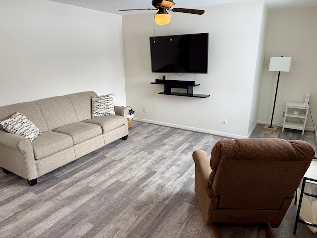 living room with hardwood / wood-style flooring and ceiling fan