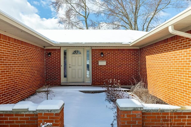 view of snow covered property entrance