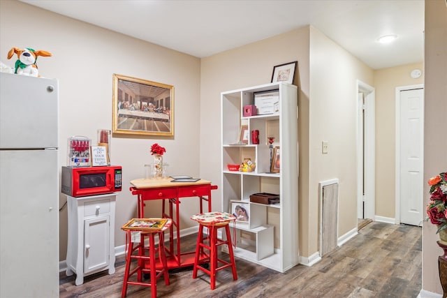 playroom with baseboards and wood finished floors