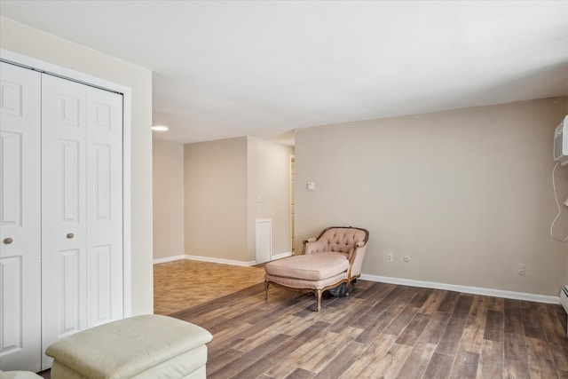 living area featuring dark wood-style flooring and baseboards