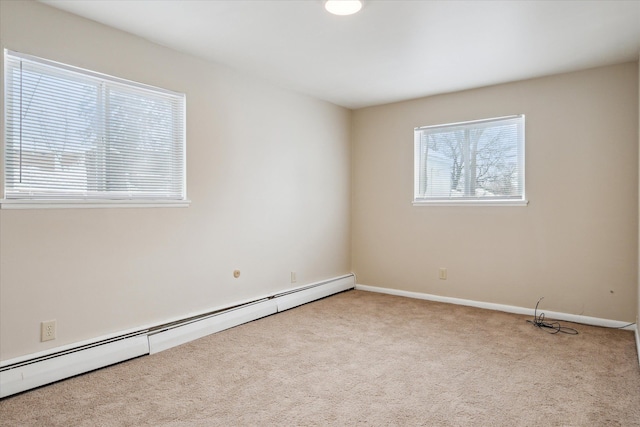 spare room featuring light carpet, a baseboard radiator, and baseboards