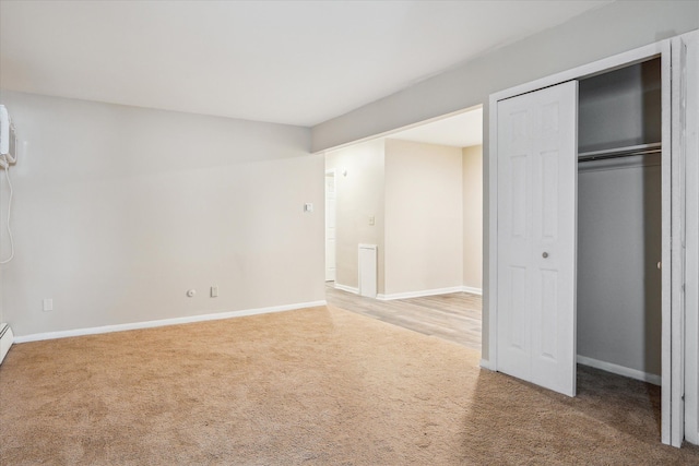 unfurnished bedroom featuring carpet floors and baseboards