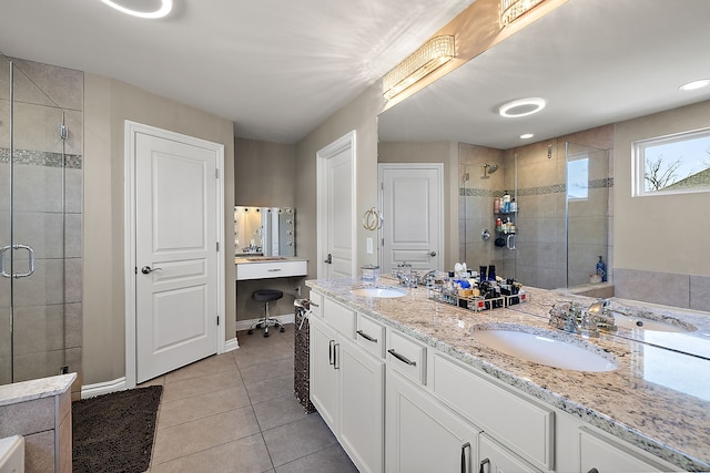 bathroom with tile patterned flooring, vanity, and walk in shower