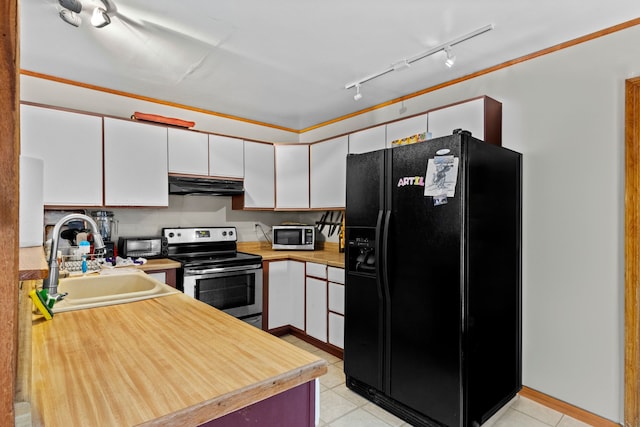 3232 5 Mile Rd, Traverse City, MI 49686 - kitchen featuring light countertops, appliances with stainless steel finishes, white cabinetry, a sink, and under cabinet range hood