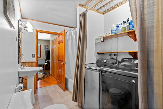3232 5 Mile Rd, Traverse City, MI 49686 - clothes washing area with light tile patterned floors, laundry area, and washer and clothes dryer