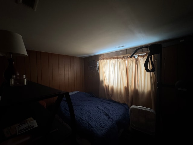 bedroom with wood walls