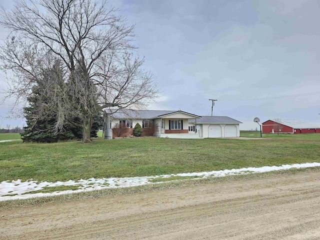 ranch-style house featuring a garage and a front lawn