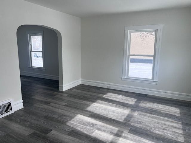 empty room with dark wood-type flooring