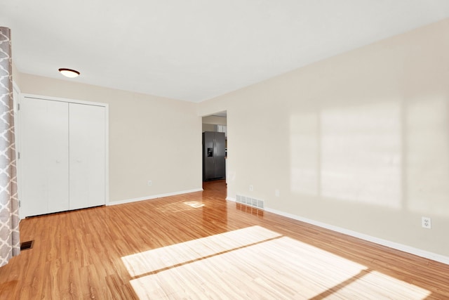 empty room with wood-type flooring