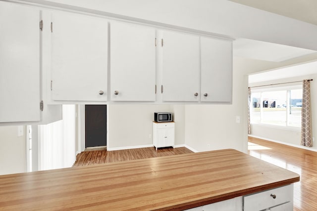 kitchen featuring light hardwood / wood-style flooring and white cabinets