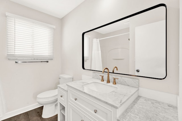 bathroom with hardwood / wood-style floors, toilet, a shower with curtain, and vanity