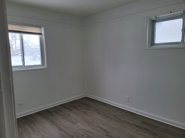 empty room with dark hardwood / wood-style floors