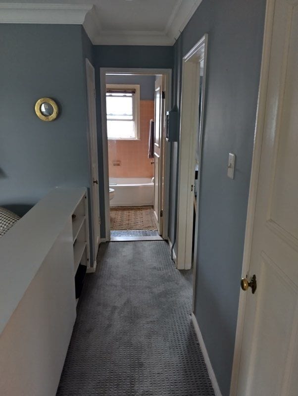 22673 Garrison St Unit 208, Dearborn, MI 48124 - corridor featuring ornamental molding, dark colored carpet, and baseboards
