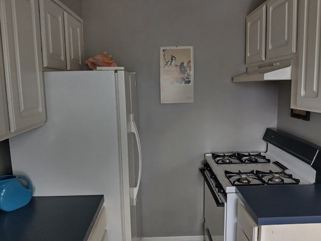 22673 Garrison St Unit 208, Dearborn, MI 48124 - kitchen with under cabinet range hood, freestanding refrigerator, range with gas cooktop, and dark countertops