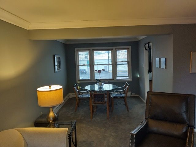 22673 Garrison St Unit 208, Dearborn, MI 48124 - carpeted dining space with ornamental molding and baseboards