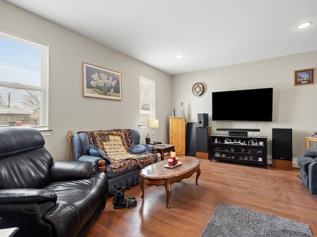 living area with a healthy amount of sunlight, wood finished floors, and recessed lighting