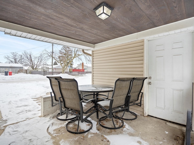 snow covered patio featuring outdoor dining space