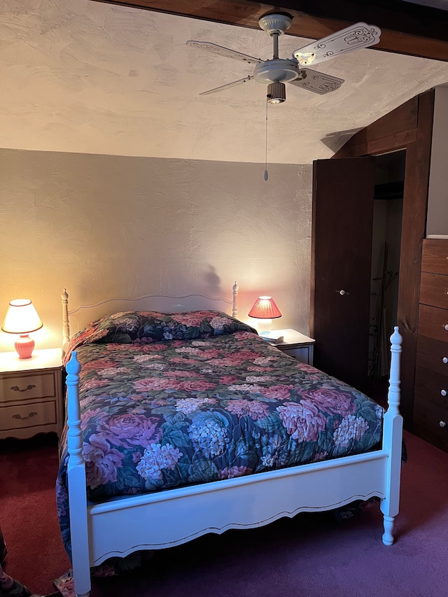 bedroom with carpet floors, a ceiling fan, and a textured wall