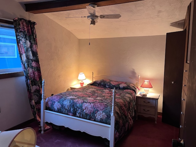 bedroom with ceiling fan, a textured wall, and lofted ceiling with beams