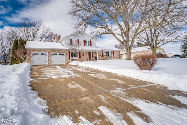 view of front of home featuring a garage, driveway, brick siding, and a chimney