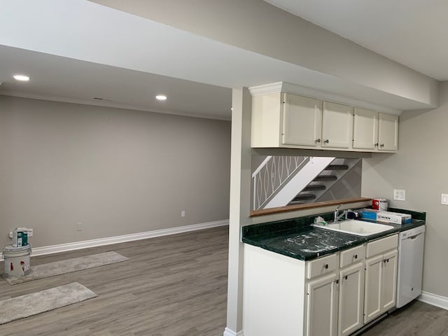 kitchen featuring sink, dark wood-type flooring, white cabinets, and white dishwasher