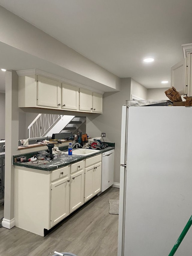 kitchen featuring white cabinets, white appliances, and light hardwood / wood-style floors