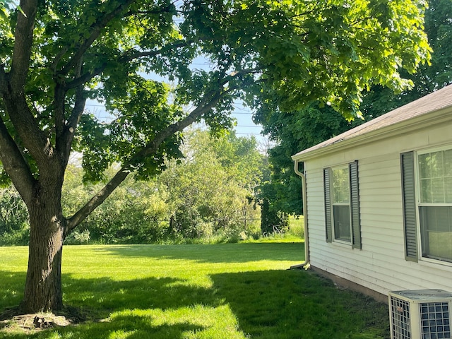 view of yard featuring central air condition unit