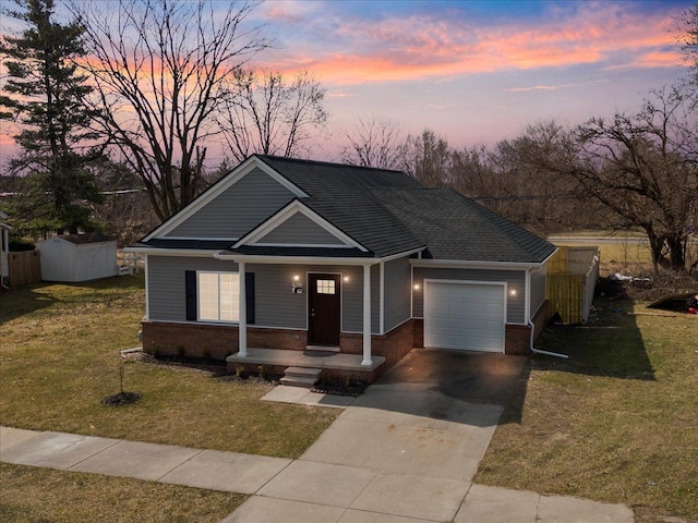 view of front of house with a yard and a garage