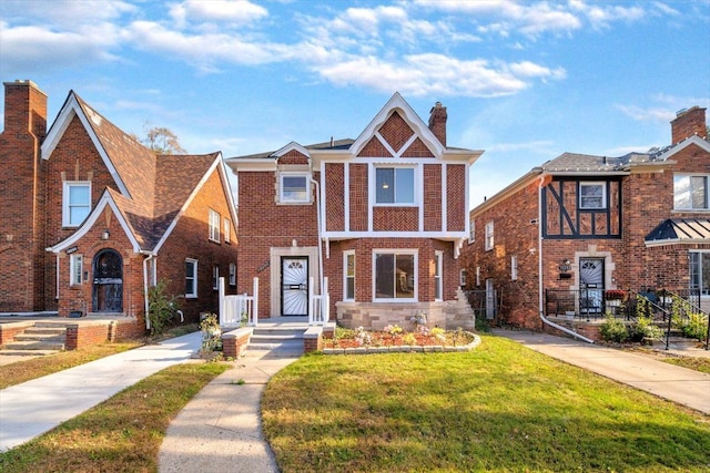 tudor-style house with a front lawn