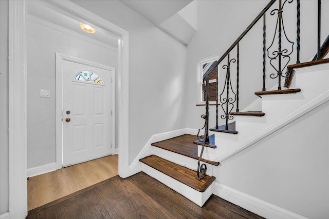 entrance foyer featuring crown molding and dark hardwood / wood-style floors