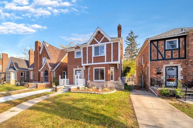 english style home with a front yard