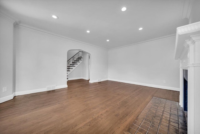 unfurnished living room with ornamental molding and dark hardwood / wood-style flooring