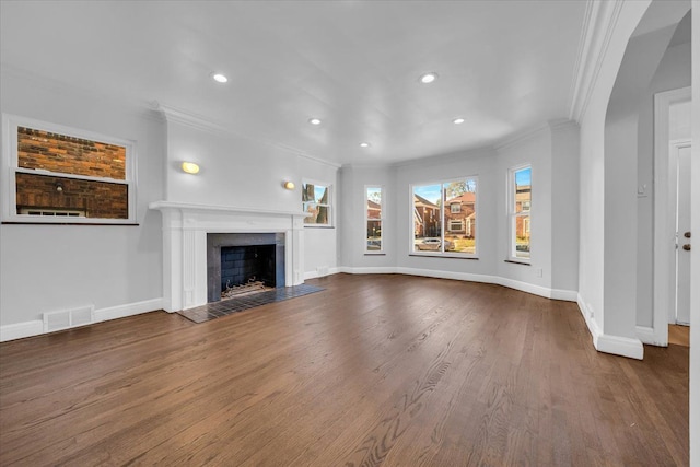 unfurnished living room with crown molding and hardwood / wood-style flooring