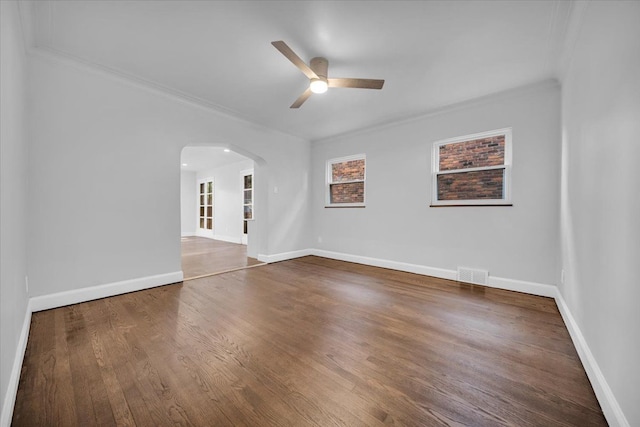 empty room featuring hardwood / wood-style flooring, ceiling fan, and crown molding