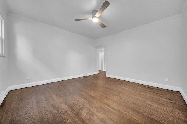 empty room with wood-type flooring, ornamental molding, and ceiling fan