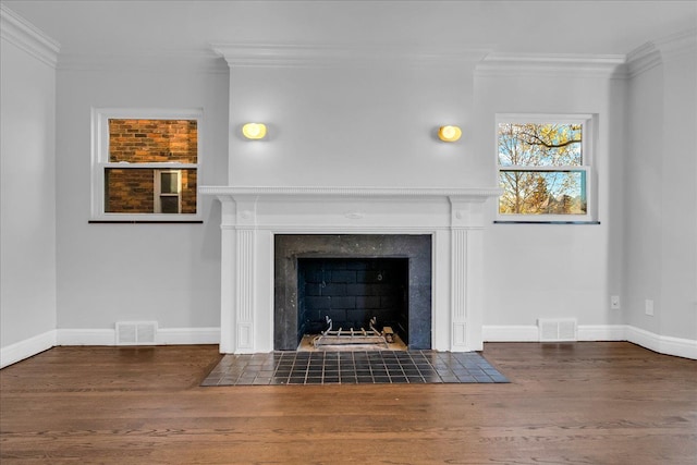 unfurnished living room with dark hardwood / wood-style floors, ornamental molding, and a fireplace