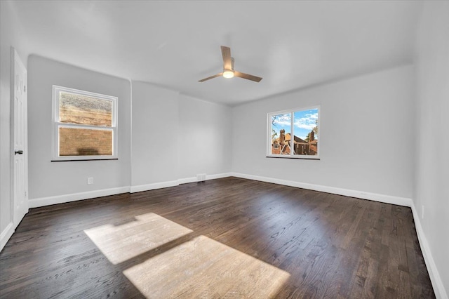 empty room featuring ceiling fan and dark hardwood / wood-style flooring