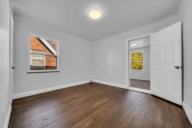 unfurnished bedroom with dark hardwood / wood-style floors