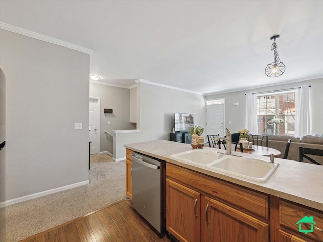 kitchen with stainless steel dishwasher, decorative light fixtures, crown molding, hardwood / wood-style floors, and sink