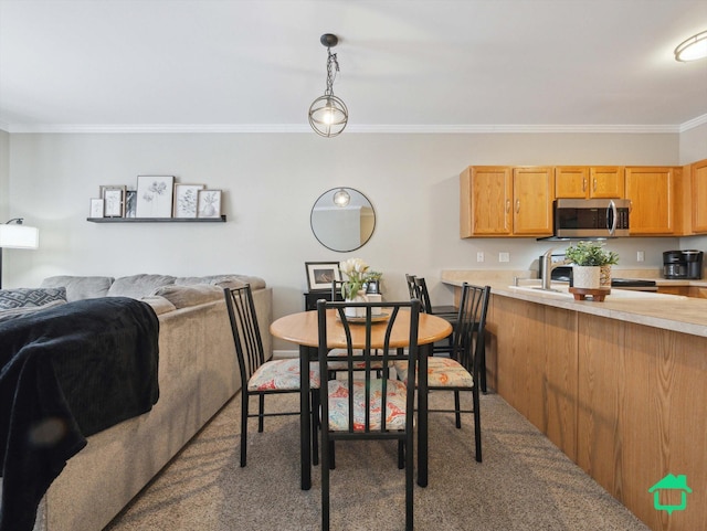 carpeted dining area featuring crown molding