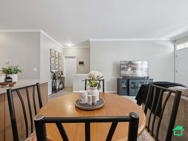 dining area with light carpet and crown molding