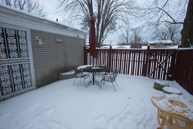 snow covered deck featuring outdoor dining space