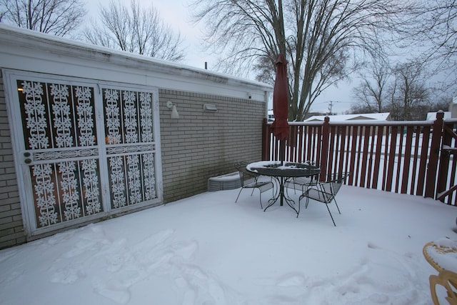 snow covered patio featuring outdoor dining area