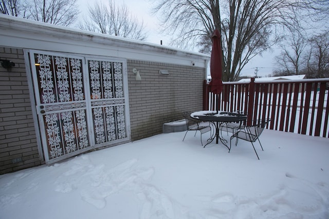 snow covered patio with outdoor dining area