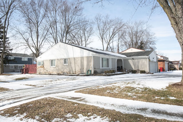 view of front of property featuring a garage and brick siding