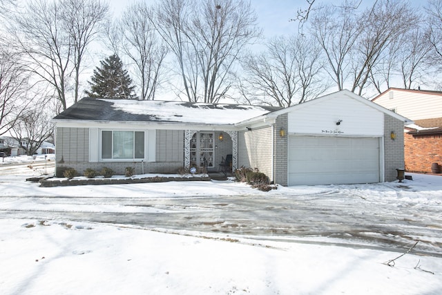 view of front of house featuring an attached garage and brick siding