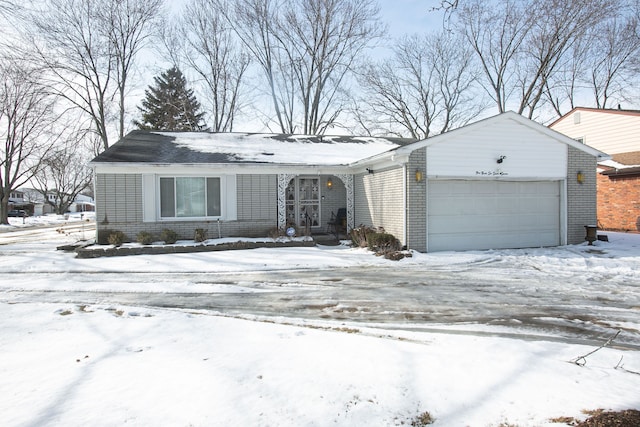 view of front of home featuring brick siding and an attached garage